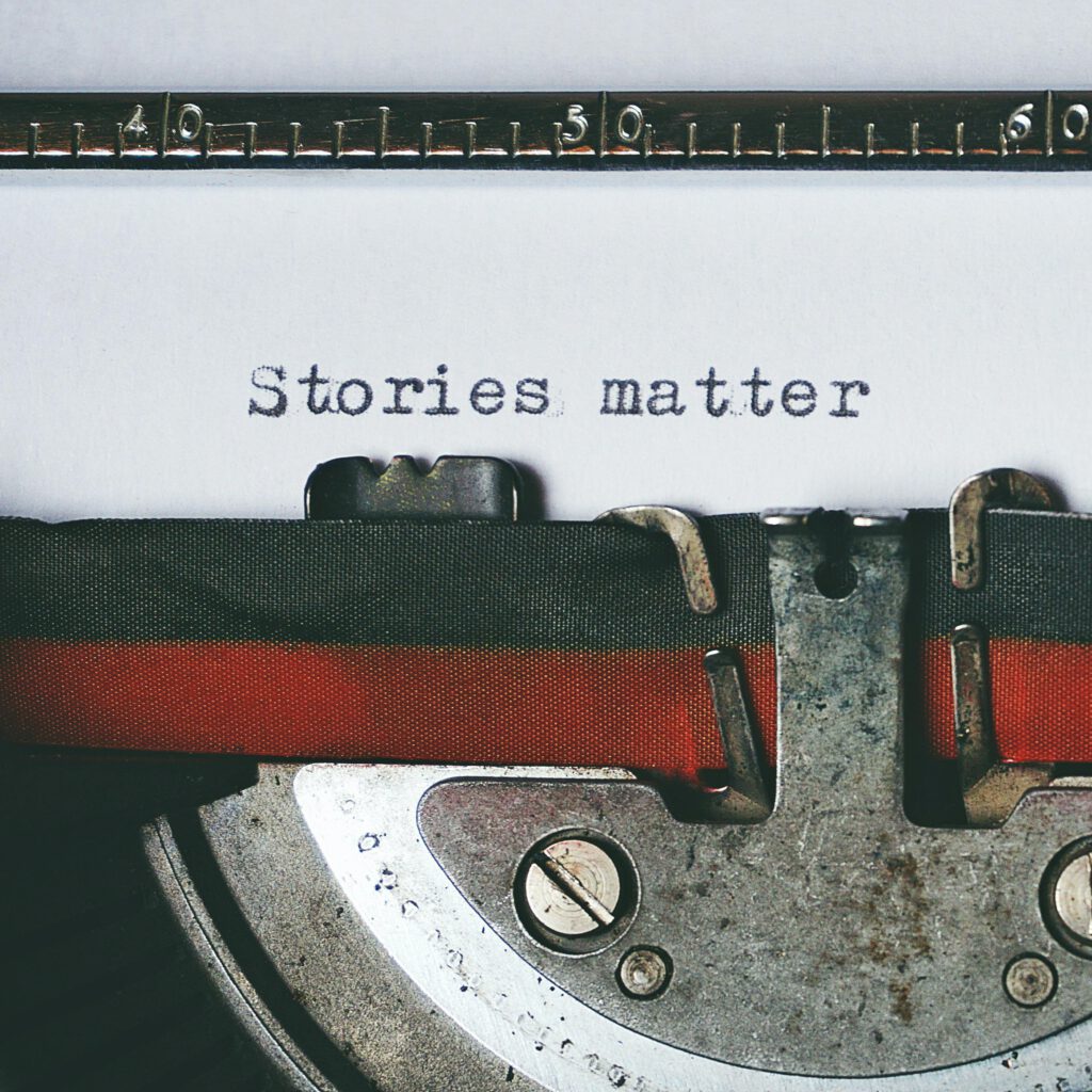 pexels-photo-1995842-1995842 Close-up of a vintage typewriter with the text 'Stories matter' typed on paper, evoking nostalgia.